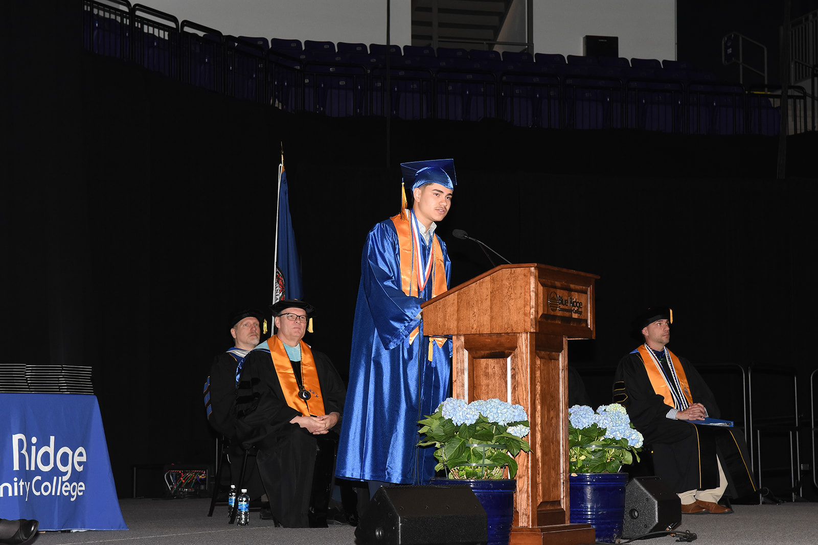 Graduate at a podium giving a speech.