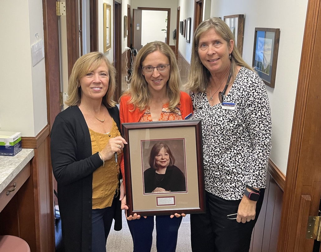 women holding a framed picture
