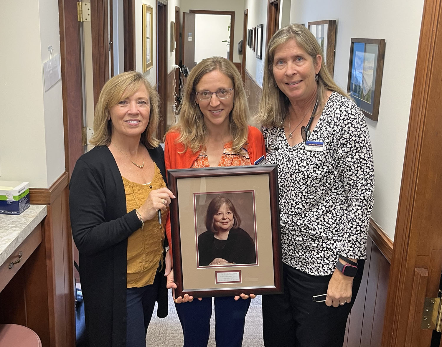 women holding a framed picture