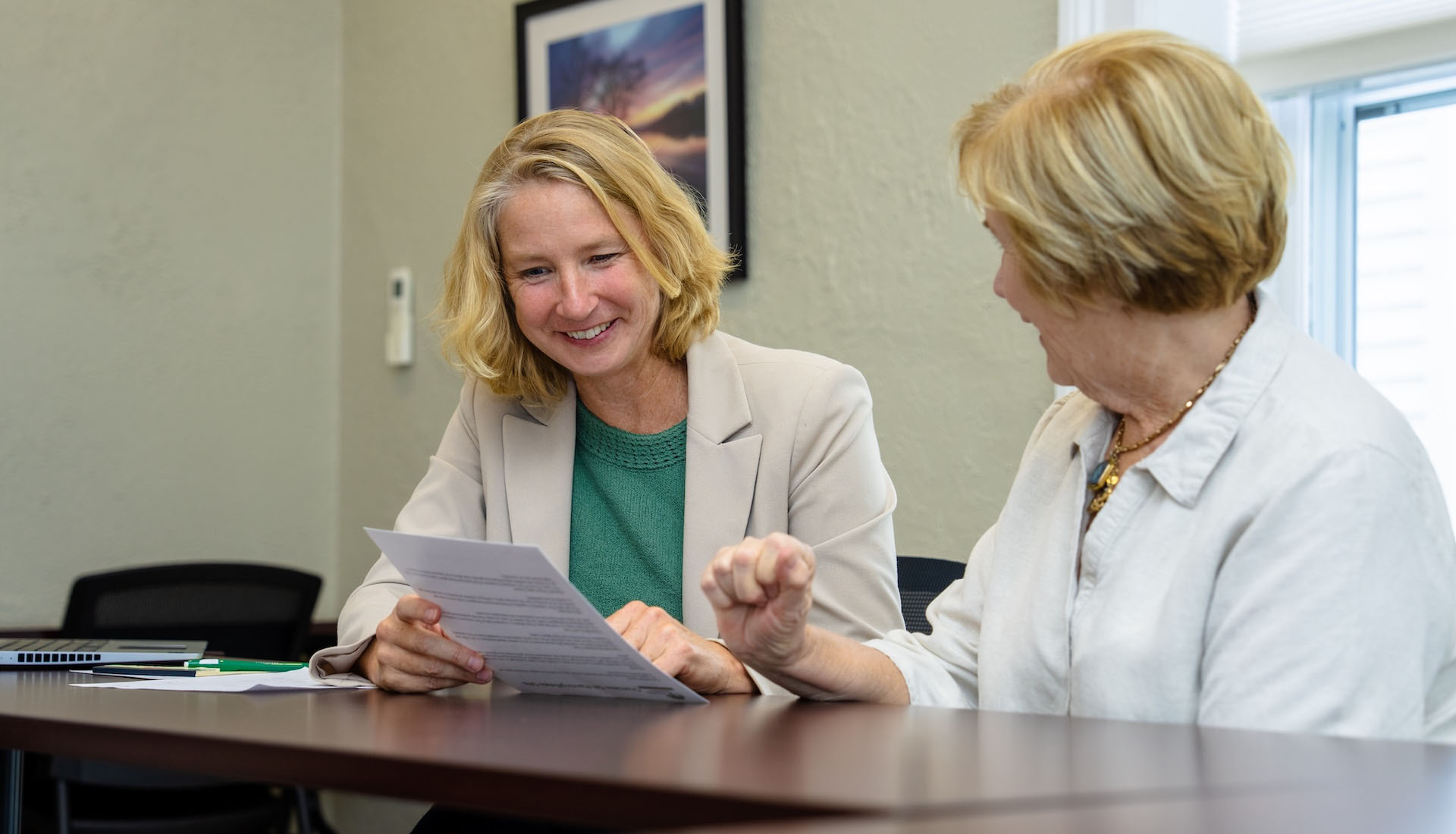two woman reviewing document